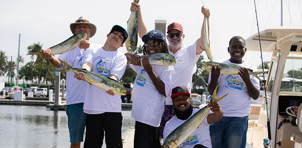 Fishing event photo with everyone holding fish they caught