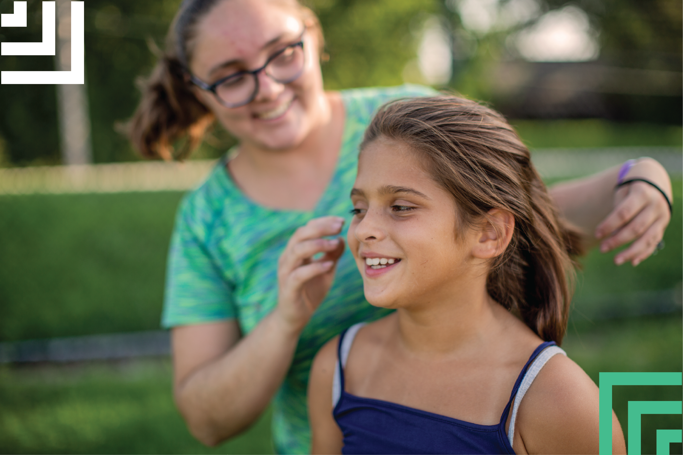 Big sister and little sister doing each others hair